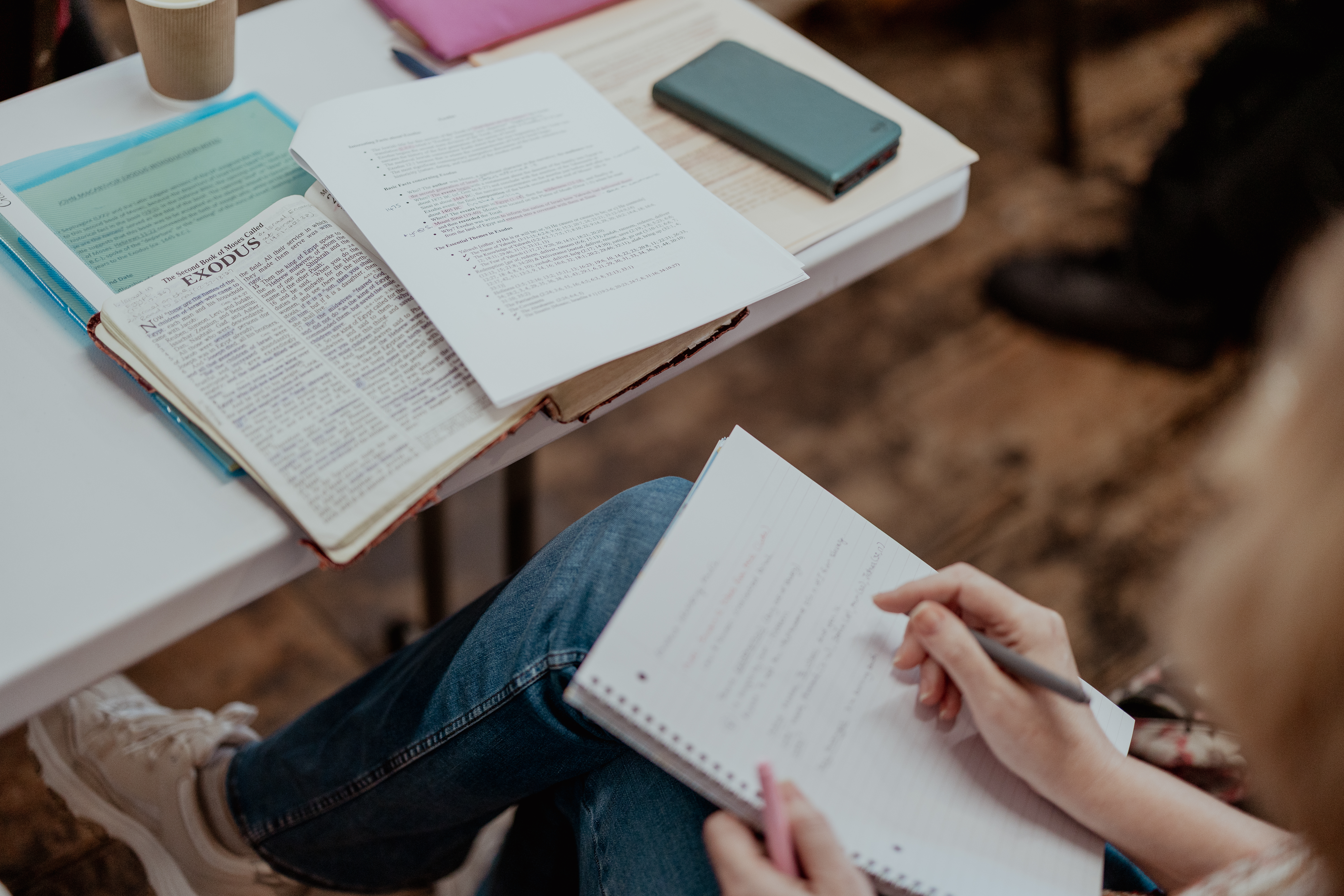 A group of Hermeneia Bible Survey Course students being taught with their Bibles open