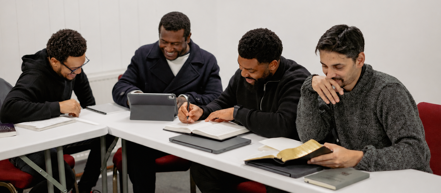 Hermeneia Master of Arts in Expository Preaching students siting around a table at lunch with a lecturer